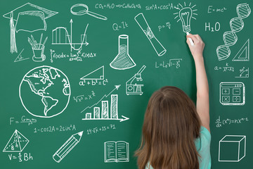 Girl Writing On Chalkboard