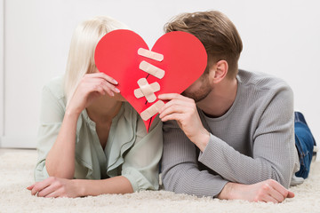 Couple Kissing Behind Heart Shape