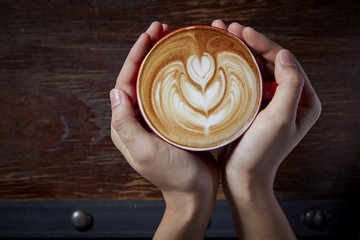 Holding a cup of coffee