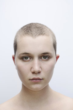 Portrait of young woman with shaved head