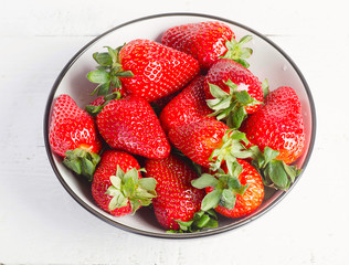 Ripe red strawberries in a bowl. Healthy eating.