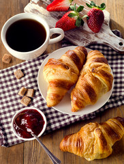 Fresh croissants with coffee cup