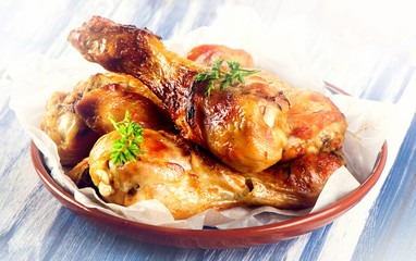 Roasted chicken legs with a fresh herbs.