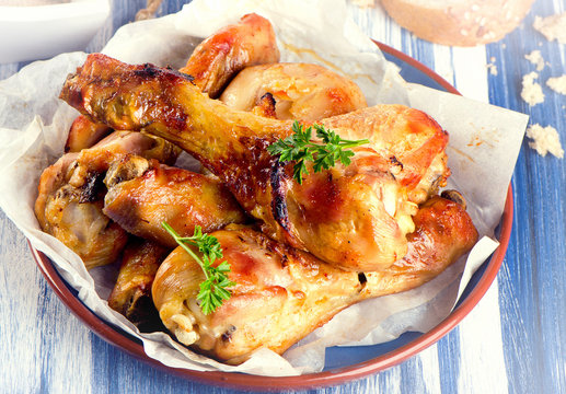 Roasted chicken legs with  bread and herbs.
