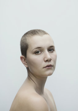 Portrait of serious Caucasian woman with shaved-head