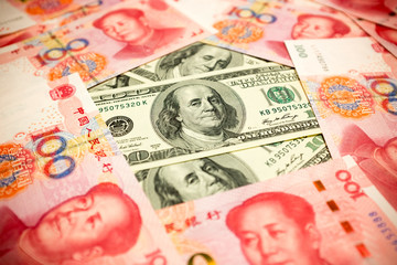 Chinese Yuan Note and U.S. dollar background  (Exchange rate concept)