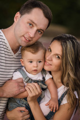 Fototapeta premium happy young family mother father son have fun in summer park