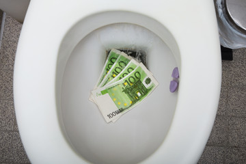 Euro Notes In The Toilet Bowl