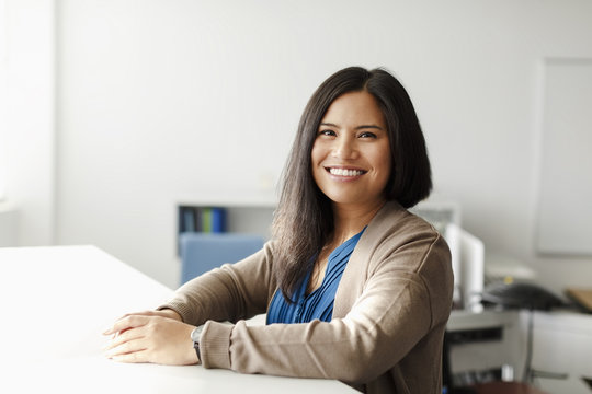 Smiling Pacific Islander woman in office