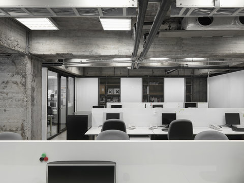 View Of Modern Office Interior With Rows Of Computers