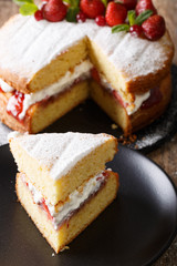 Sliced Victoria sandwich cake closeup on a plate. vertical
