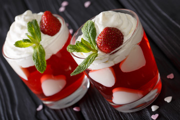 festive strawberry dessert for lovers, decorated with hearts and fresh mint in closeup. horizontal
