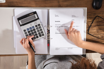Businessperson Calculating Invoice