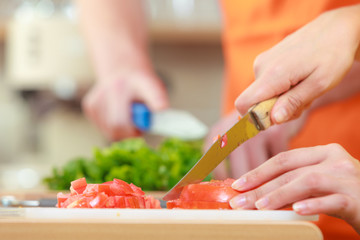 Couple preparing fresh vegetables food salad