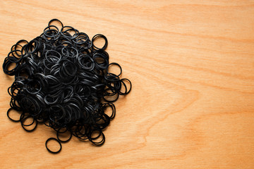 A pile of elastic bands for hair on a wooden table