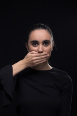 one young woman, hand covering mouth