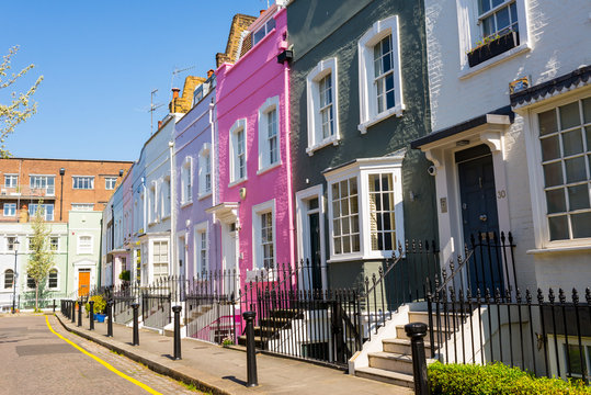 Pastel colored restored Victorian British houses in an elegant mews in Chelsea, London, UK
