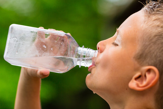 Young boy drinking water from bottle