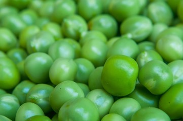 Background of fresh green peas. Selective focus. Macro shot