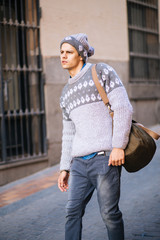 Confident and handsome young man in the street