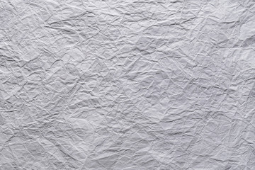 White crumpled sheet of paper textured background with copy space for text or image.