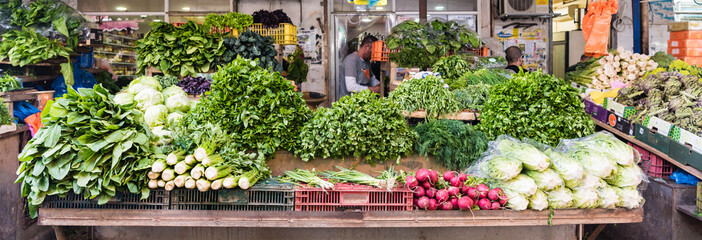 Fresh green vegetables and roots in Carmel market Tel Aviv 