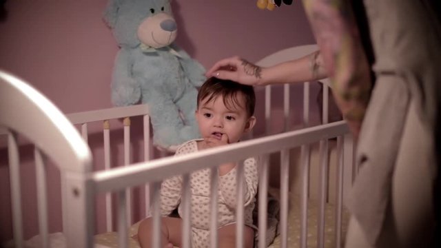 Male toddler in the crib over night time 