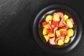 roasted Potato with ham on black plate