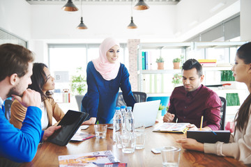 Muslim woman leading on business meeting