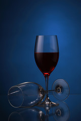 Wineglasses with red wine on blue