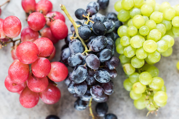 Clusters Blue Red White Grapes on Grey Background