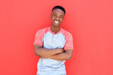 young african man smiling against red background