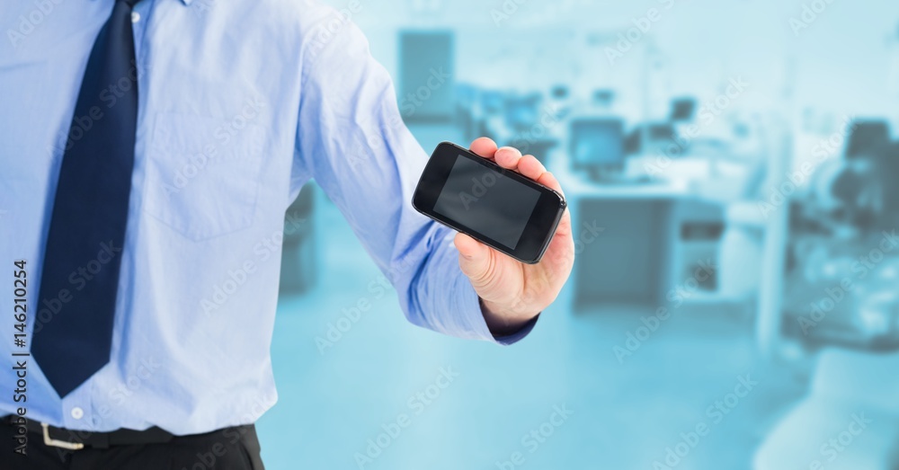 Poster Midsection of businessman showing blank screen on mobile phone