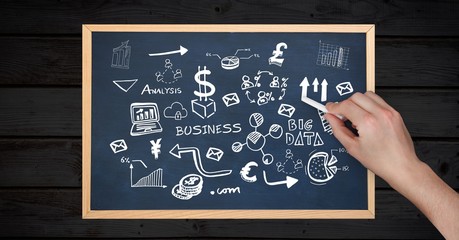Hand drawing business diagrams on slate