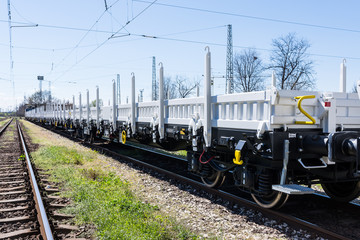 Burgas, Bulgaria - March 20, 2017 - Freight cargo train - 4axled flat wagon white Type:Rens...