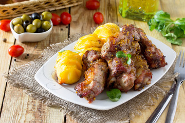 The lamb beats off the grills. Potatoes baked with cheese. Festive table.