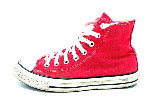 Old red sneaker isolated on white background / Image Selective focus.