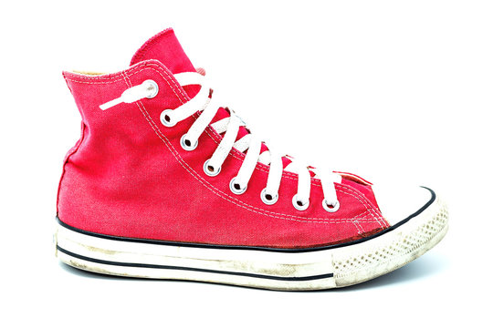 Old red sneaker isolated on white background / Image Selective focus.
