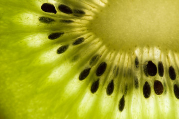 detail of sliced kiwifruit with seeds and light