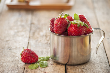 Ripe red strawberries on wooden table