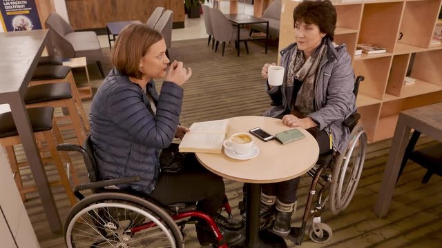 Two physically challenged women in a cafe