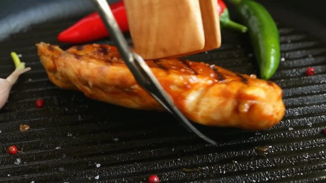 Grilled chicken fillet on a grill