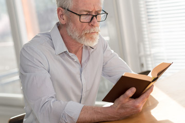 Fototapeta na wymiar Mature man reading a book