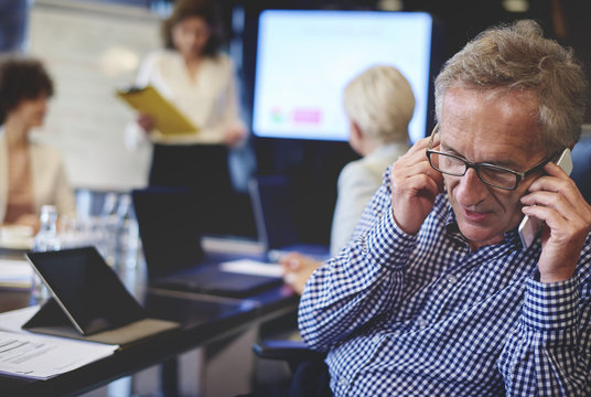 Business man picking up the urgent phone .