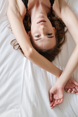 Fototapeta premium Pretty sexy brunette woman lies on bed