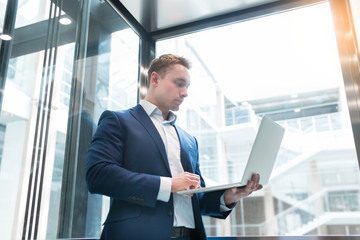 Businessman in elevator in the office center