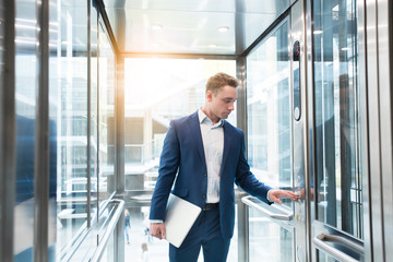 Businessman in elevator in the office center