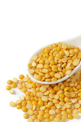 Dry yellow split peas isolated on white.