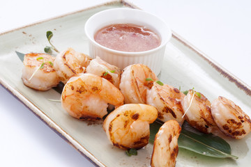 shrimp with sauce on a bamboo leaf