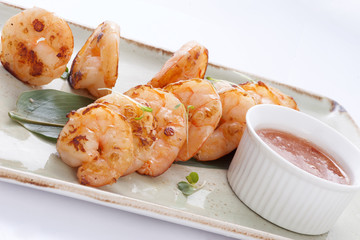 shrimp with sauce on a bamboo leaf